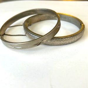 Two silver colored bangles. No markings that suggest it’s real silver